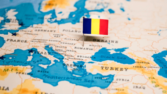 This is an image of a map of Europe with the flag of Romania pinned to Romania.