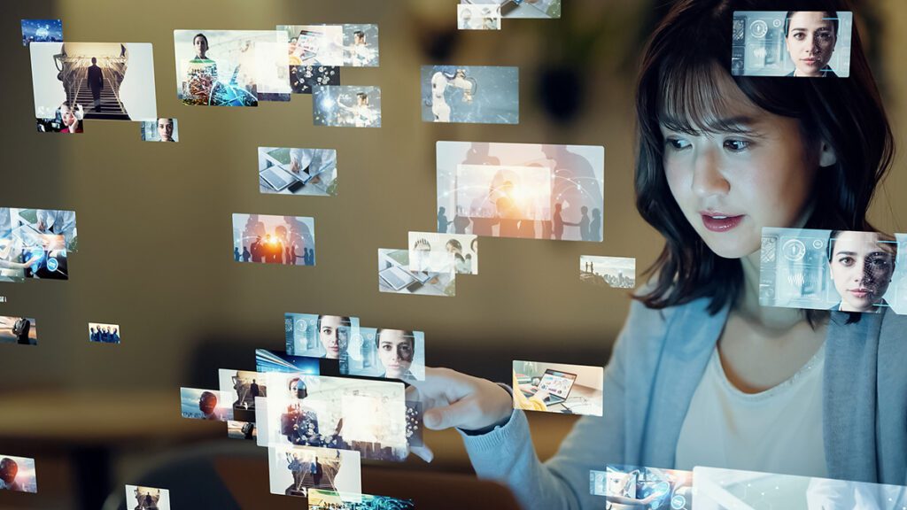 A woman looks at a variety of futuristic digital images.