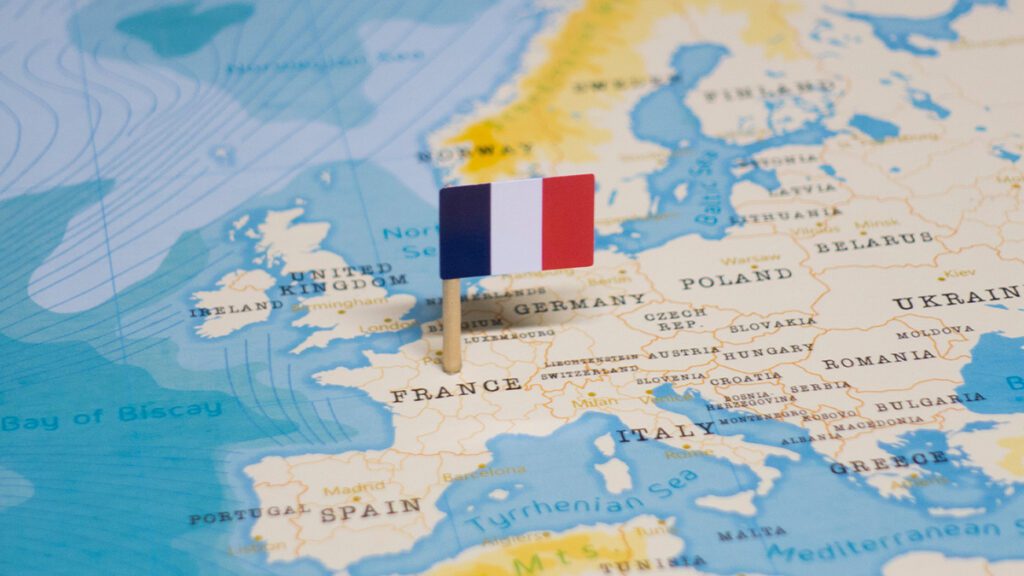 This is an image of the flag of France pinned to a map of Europe.