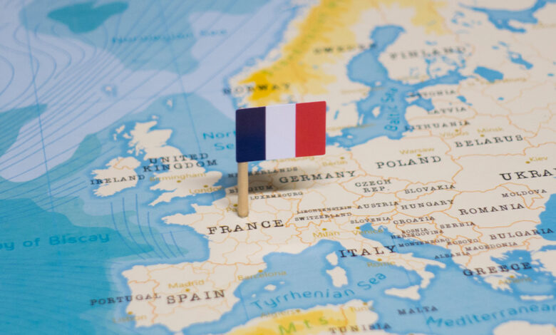 This is an image of the flag of France pinned to a map of Europe.