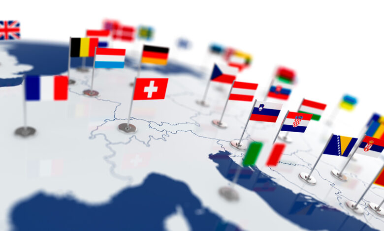 Image of the map of Europe with various flags of European countries pinned to it.