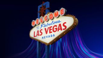 The iconic "Welcome to Las Vegas" sign with a dark blue background