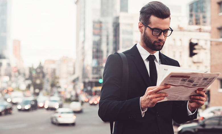 decorative image of a man reading a newspaper