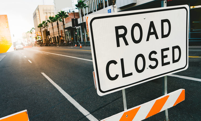 Image displays a road closure sign.