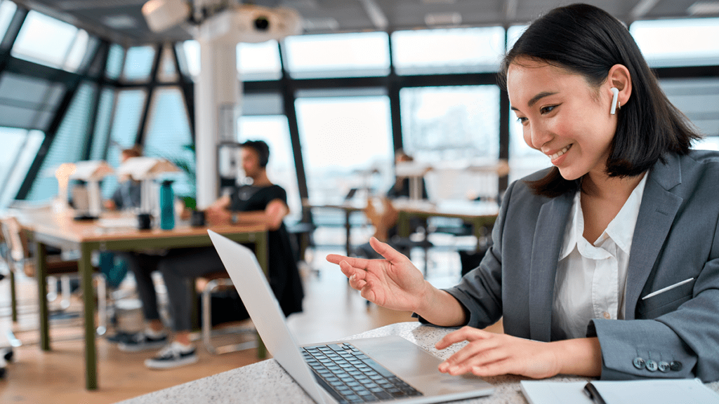Female professional on a laptop working in a hybrid work environment.