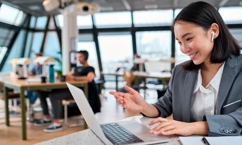 Female professional on a laptop working in a hybrid work environment.