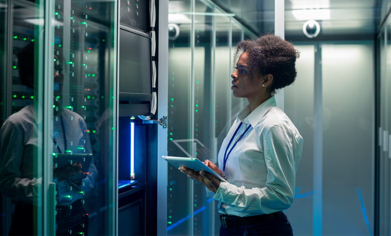 Woman viewing set of mainframes