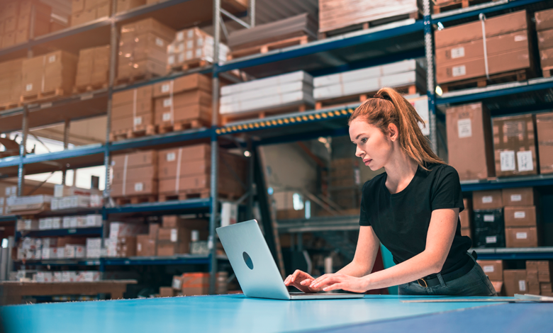 This is an image of a woman fulfilling orders within a warehouse, representing order fulfillment at The Consortium Clemenger.
