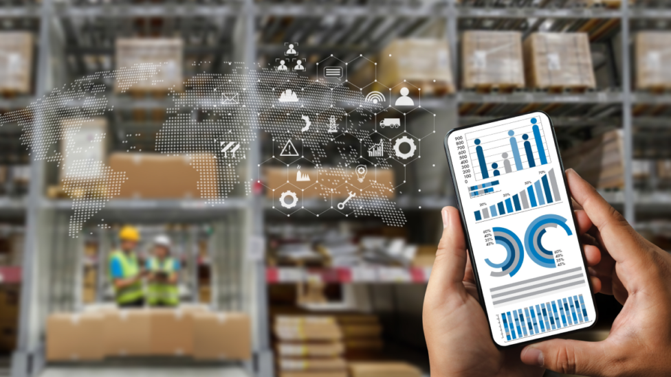 Person holding smart device to leverage AI and IoT to manage their supply chain