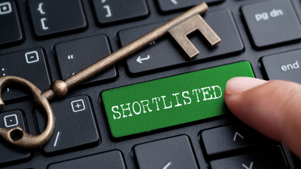 close-up short of a keyboard, and a man's finger is pressing a green key that reads 