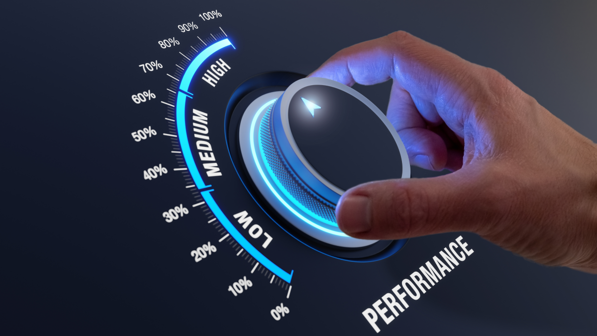 hand reaching in from right side to adjust a dial that indicates performance; they are turning up performance to "high"; black background with a colourful lighted dial