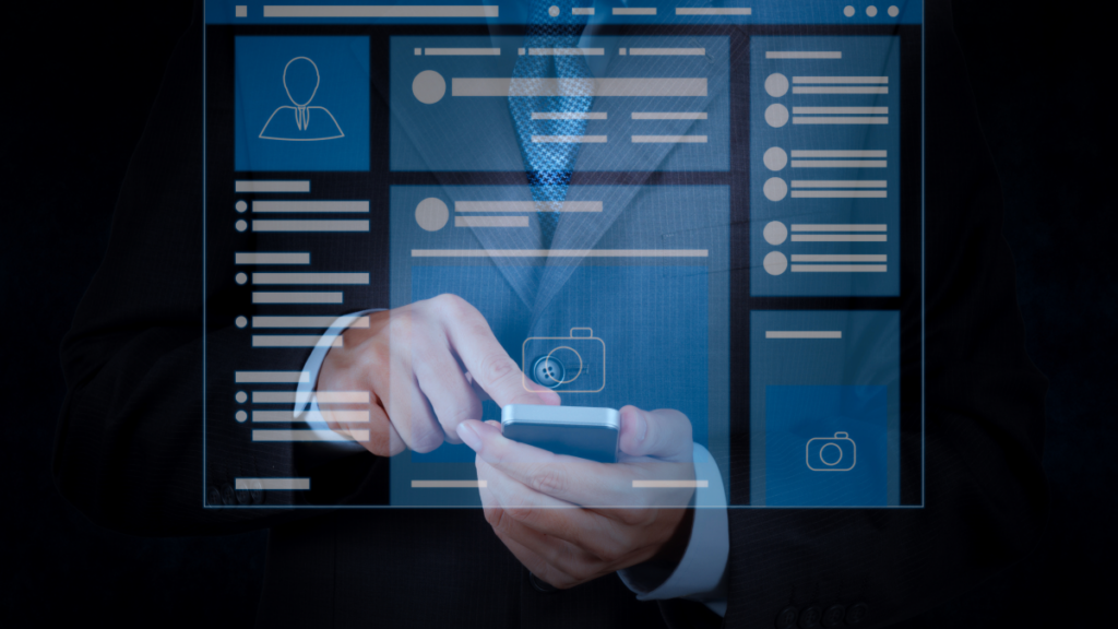 Hand touching phone with windows reflected on screen