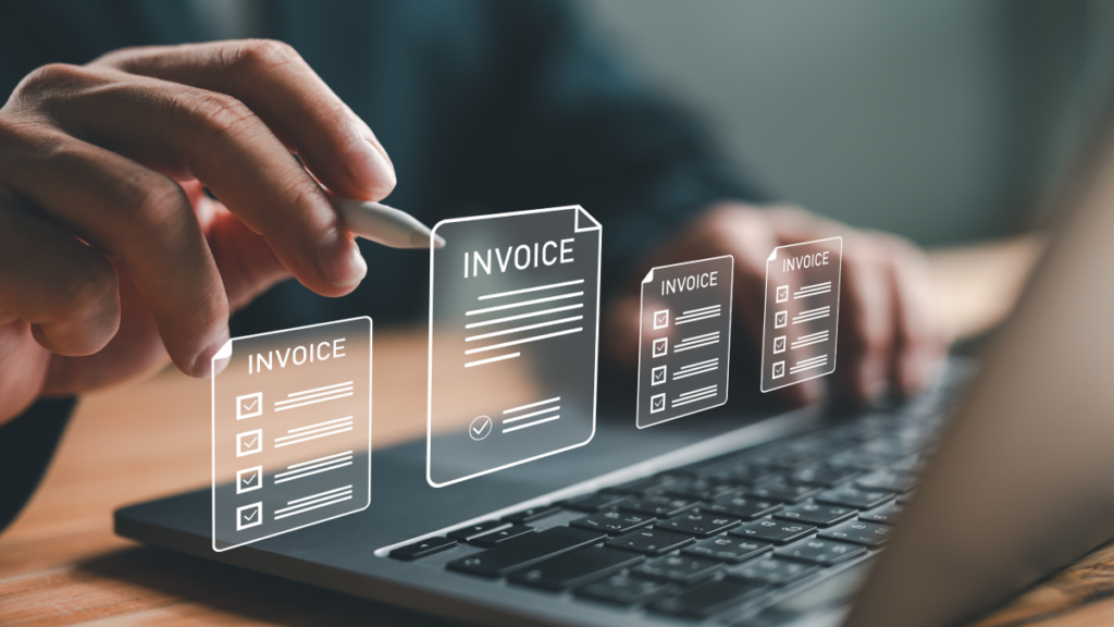 hands typing on a laptop with graphics overlaid that show e-invoices
