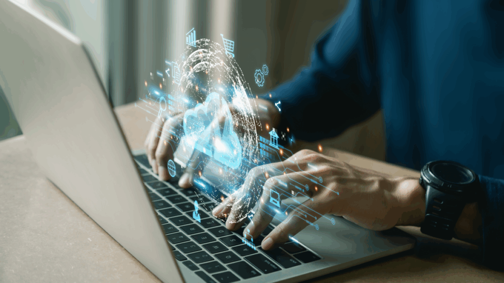 two hands typing on a laptop keyboard with graphics floating above it