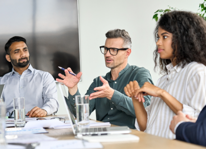 two men and a woman in an executive team meeting