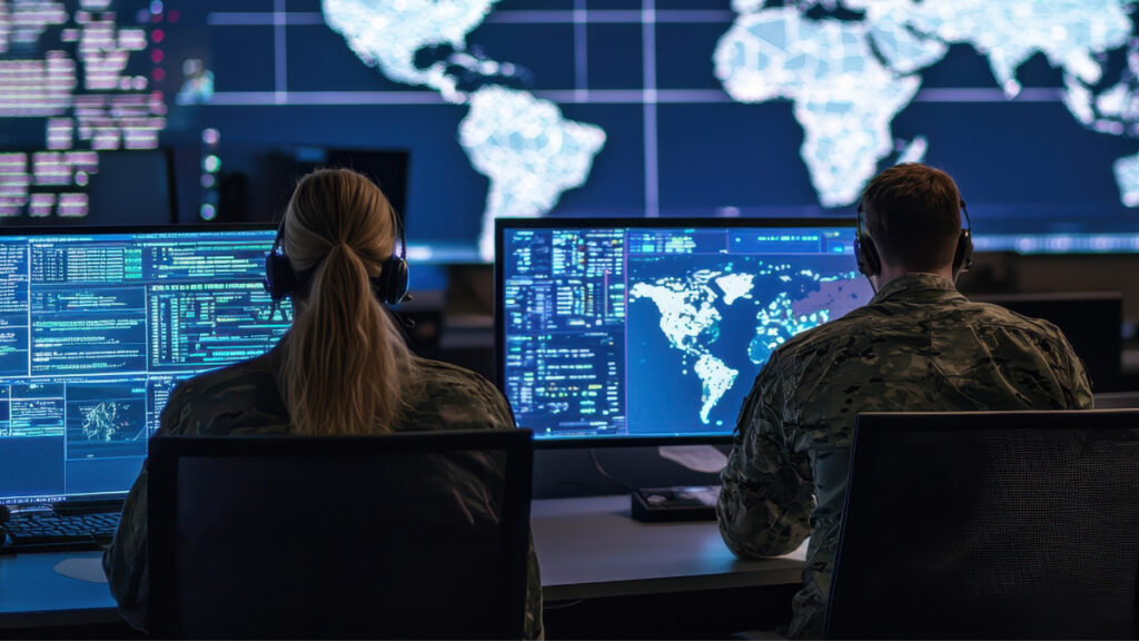 Military personnel sitting at computers at a command center