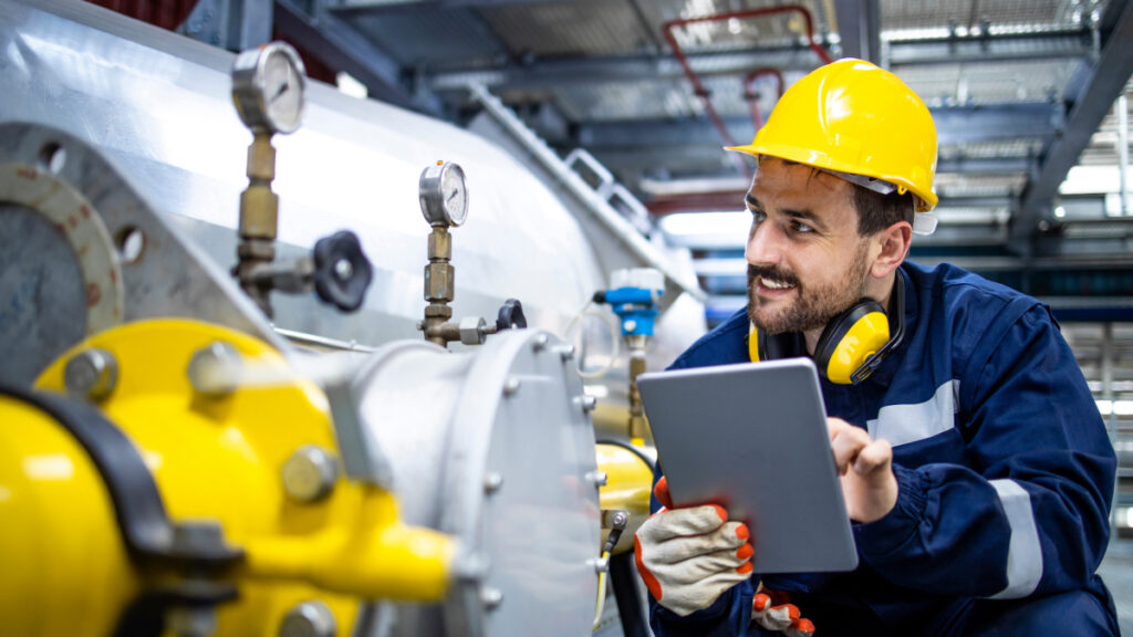 Utilities worker inspecting gas tank