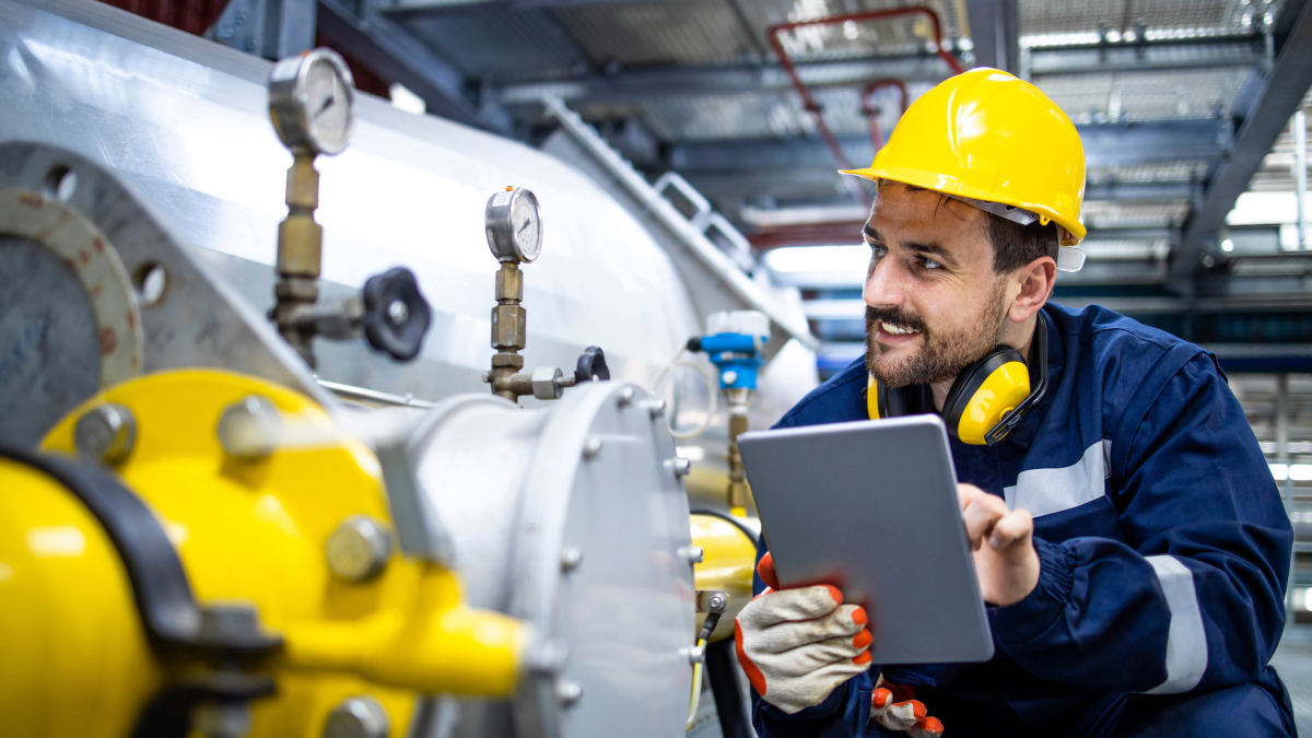Utilities worker inspecting gas tank