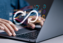 open laptop with worker typing; a devops infinity loop floats over his hands, indicating devops for regulated industries and devops compliance.