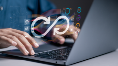 open laptop with worker typing; a devops infinity loop floats over his hands, indicating devops for regulated industries and devops compliance.