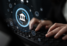 workers hands at keyboard; icons float above it, and the largest is a bank icon, indicating bank connectivity strategy